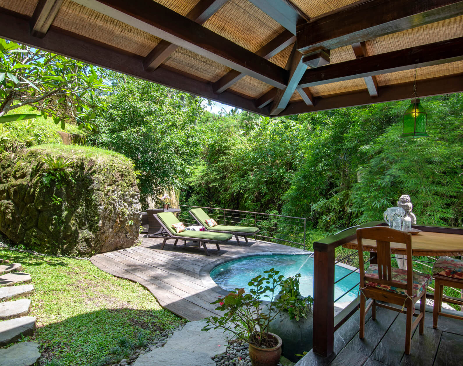 Traditional wooden villa with private pool surrounded by tropical garden at Lumina Bali