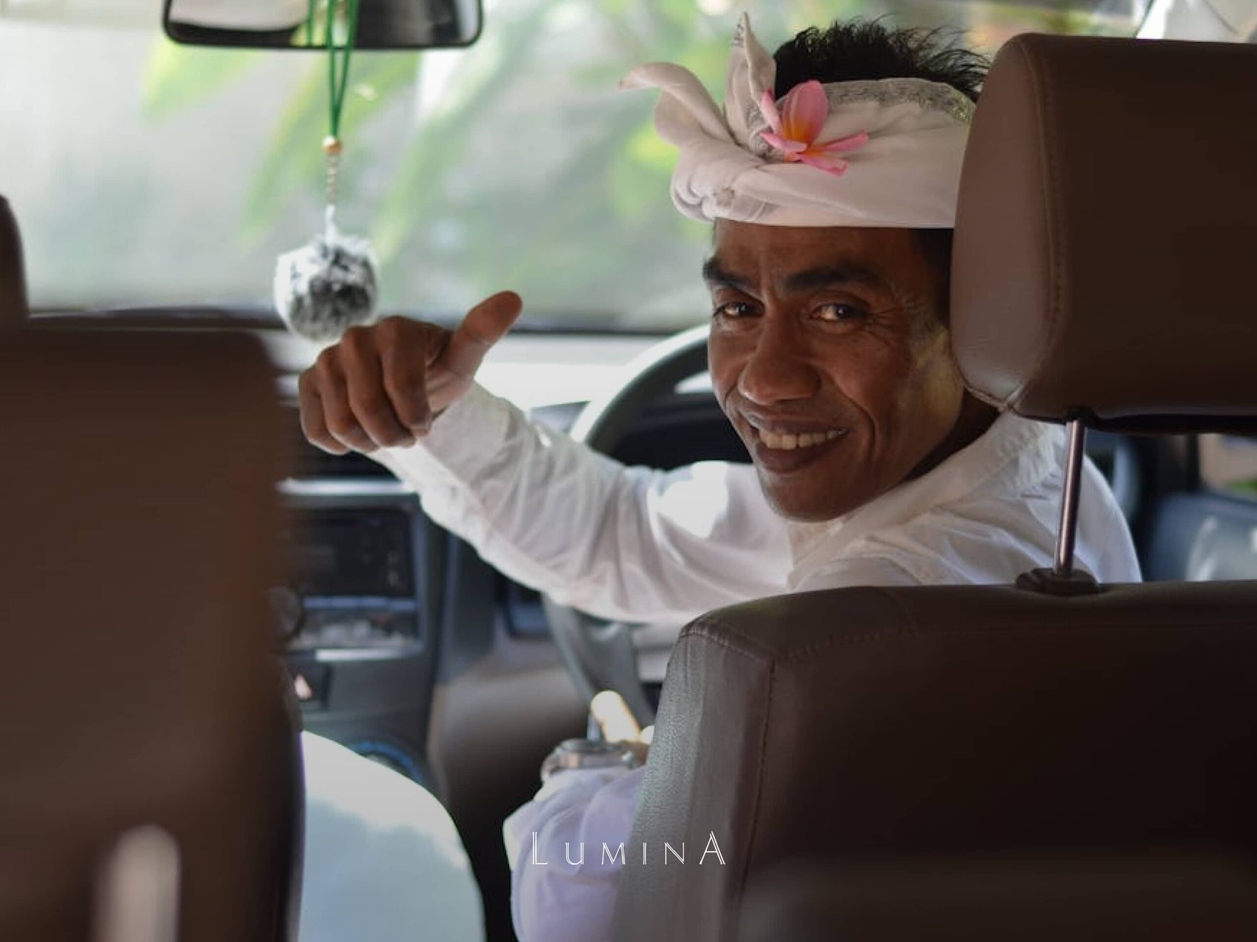 Friendly Balinese driver offering private airport transfer service at Lumina Bali