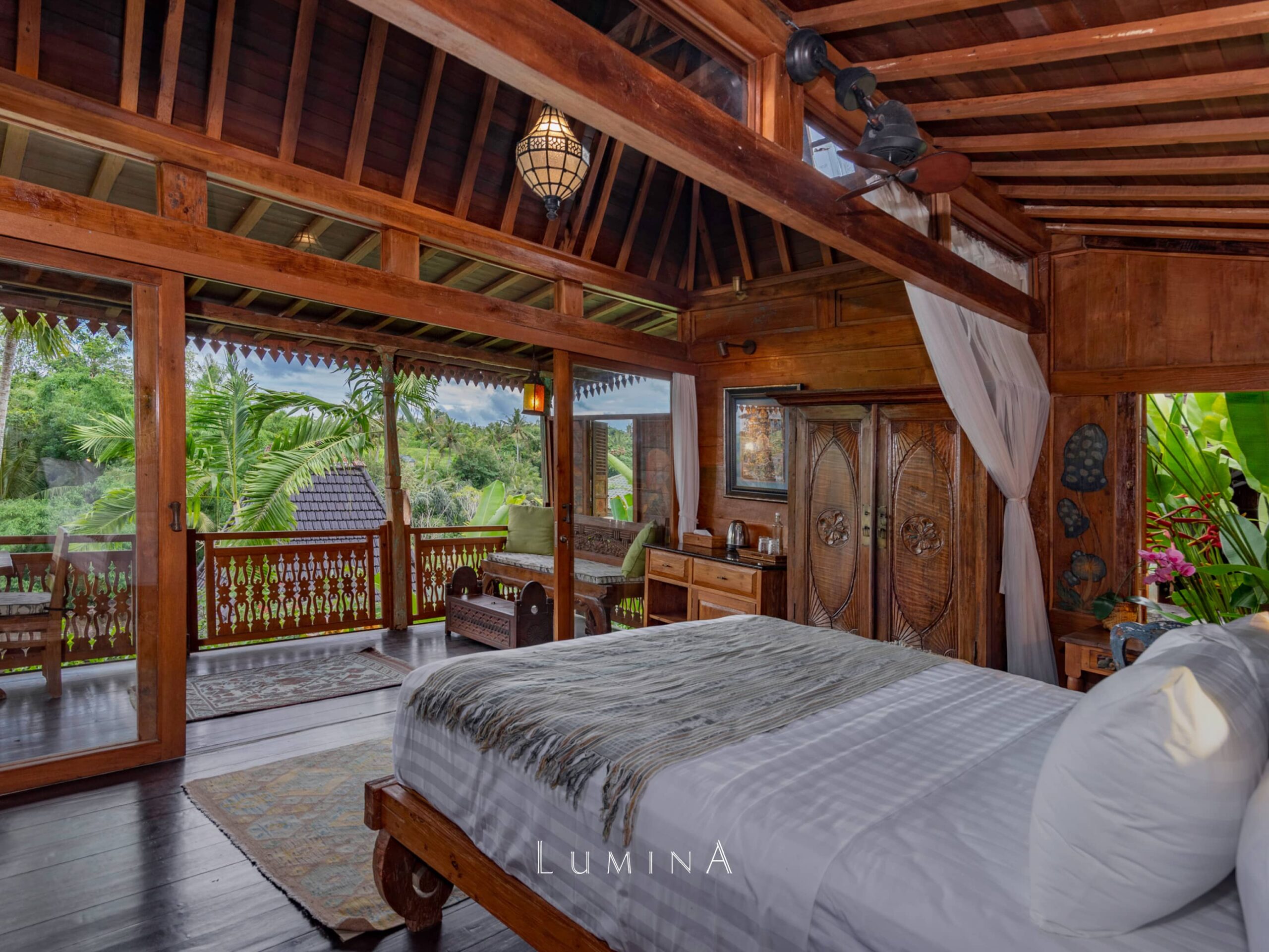 teakwood cottage bedroom with open-air view at Lumina Wellness Retreat Ubud